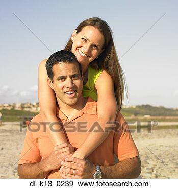 Stock Photograph - portrait of a 
mid adult woman 
riding piggyback 
on a mid adult 
man. fotosearch 
- search stock 
photos, pictures, 
images, and photo 
clipart