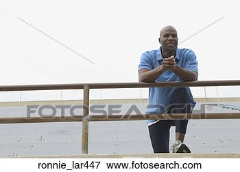 Picture - portrait of a 
mid adult man 
leaning over a 
railing. fotosearch 
- search stock 
photos, pictures, 
images, and photo 
clipart
