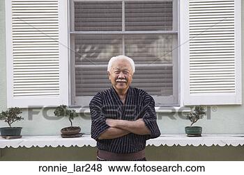 Stock Photo - portrait of a 
senior man standing 
with his arms 
crossed. fotosearch 
- search stock 
photos, pictures, 
images, and photo 
clipart