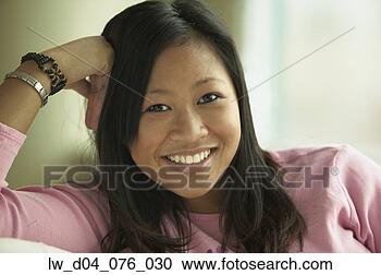 Stock Photography - portrait of a 
teenage girl smiling 
with her hand 
on her head. fotosearch 
- search stock 
photos, pictures, 
images, and photo 
clipart