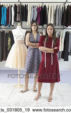 Stock Photograph - portrait of two 
fashion designers 
standing in front 
of a mannequin. 
fotosearch - search 
stock photos, 
pictures, images, 
and photo clipart