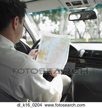 Stock Photo - rear view of a 
businessman sitting 
in a car and looking 
at a road map. 
fotosearch - search 
stock photos, 
pictures, images, 
and photo clipart