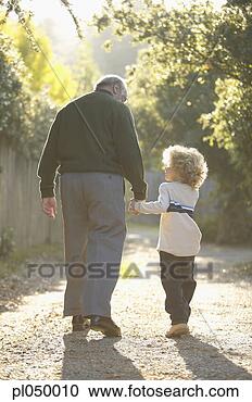 Stock Photography - rear view of a 
grandfather walking 
with his granddaughter. 
fotosearch - search 
stock photos, 
pictures, images, 
and photo clipart