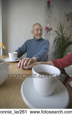Stock Photography - senior man holding 
hands of a senior 
woman. fotosearch 
- search stock 
photos, pictures, 
images, and photo 
clipart