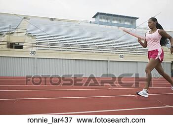 Picture - side profile of 
an athlete running 
on the running 
track. fotosearch 
- search stock 
photos, pictures, 
images, and photo 
clipart