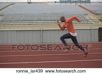Stock Photograph - side profile of 
an athlete running 
on the running 
track. fotosearch 
- search stock 
photos, pictures, 
images, and photo 
clipart