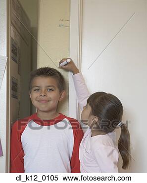 Stock Image - side profile of 
a sister measuring 
her brother's 
height. fotosearch 
- search stock 
photos, pictures, 
images, and photo 
clipart