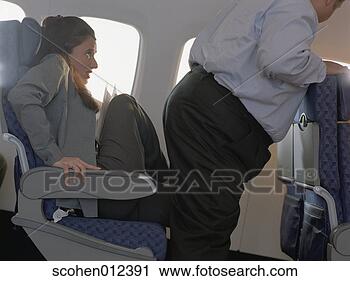 Stock Photography - woman sitting 
with her feet 
up on the seat 
giving way for 
a man to. fotosearch 
- search stock 
photos, pictures, 
images, and photo 
clipart