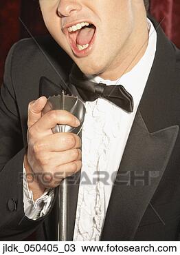 Stock Photo - young man singing 
into a microphone. 
fotosearch - search 
stock photos, 
pictures, images, 
and photo clipart