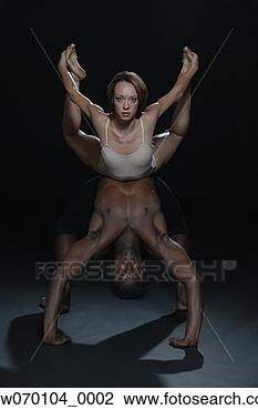 Stock Photo - interracial couple 
performing gymnastics. 
fotosearch - search 
stock photos, 
pictures, images, 
and photo clipart