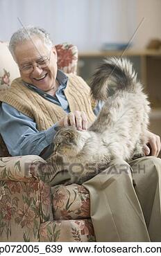 Stock Photograph - older man in an 
arm chair petting 
his cat. fotosearch 
- search stock 
photos, pictures, 
images, and photo 
clipart