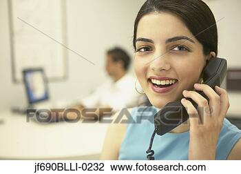 Stock Photo - young businesswoman 
talking on the 
phone. fotosearch 
- search stock 
photos, pictures, 
images, and photo 
clipart