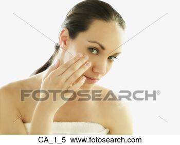 Stock Image - young woman applying 
skin lotion. fotosearch 
- search stock 
photos, pictures, 
images, and photo 
clipart