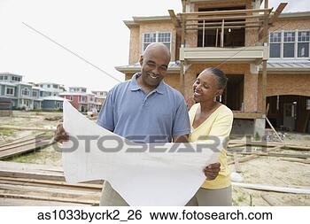 Stock Photo - african american 
couple reading 
house plans with 
house being built 
in. fotosearch 
- search stock 
photos, pictures, 
images, and photo 
clipart