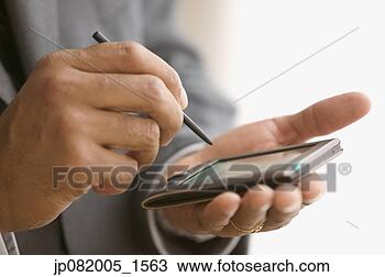 Stock Photo - close up of man 
with handheld 
organizer. fotosearch 
- search stock 
photos, pictures, 
images, and photo 
clipart