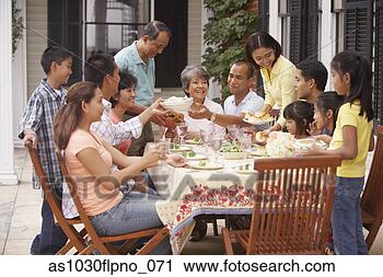 Stock Photography - family eating 
outside. fotosearch 
- search stock 
photos, pictures, 
images, and photo 
clipart