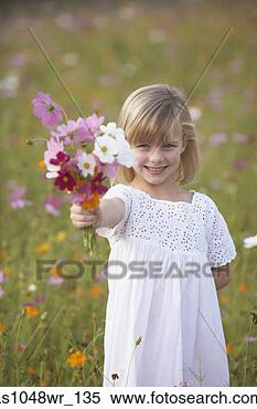 Stock Image - girl in field 
of wildflowers 
with bouquet. 
fotosearch - search 
stock photos, 
pictures, images, 
and photo clipart