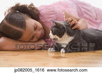 Stock Photo - girl laying petting 
cat. fotosearch 
- search stock 
photos, pictures, 
images, and photo 
clipart