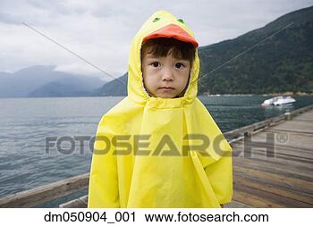 Stock Photography - portrait of boy 
in ducky raincoat. 
fotosearch - search 
stock photos, 
pictures, images, 
and photo clipart