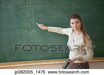Stock Photo - portrait of female 
teacher point 
to words on chalkboard. 
fotosearch - search 
stock photos, 
pictures, images, 
and photo clipart