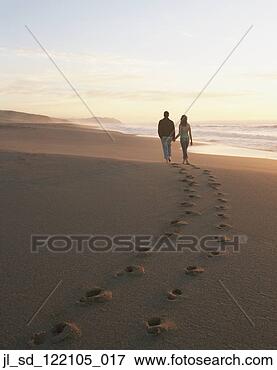 Picture - rear view of couple 
walking on beach. 
fotosearch - search 
stock photos, 
pictures, wall 
murals, images, 
and photo clipart