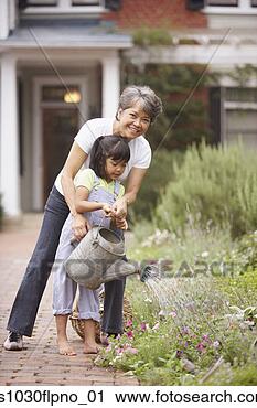Stock Photography - woman and girl 
watering flowers. 
fotosearch - search 
stock photos, 
pictures, images, 
and photo clipart