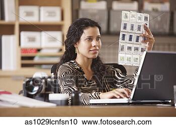 Stock Photography - woman looking 
at slides. fotosearch 
- search stock 
photos, pictures, 
images, and photo 
clipart