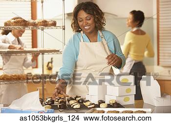 Stock Photo - woman packing 
baked goods at 
bakery. fotosearch 
- search stock 
photos, pictures, 
images, and photo 
clipart
