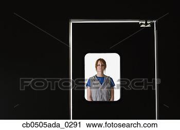 Stock Photography - woman standing 
behind door window. 
fotosearch - search 
stock photos, 
pictures, images, 
and photo clipart