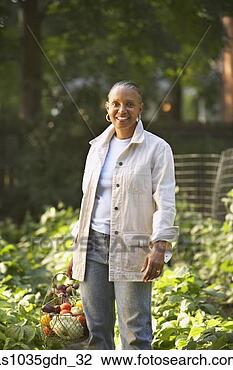 Stock Photo - woman standing 
in garden. fotosearch 
- search stock 
photos, pictures, 
images, and photo 
clipart