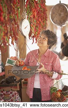 Stock Photography - woman weighing 
tomatoes at market. 
fotosearch - search 
stock photos, 
pictures, images, 
and photo clipart
