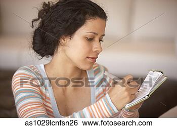 Stock Photo - woman writing 
in checkbook. 
fotosearch - search 
stock photos, 
pictures, images, 
and photo clipart
