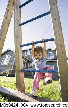 Stock Photo - young girl playing 
on play structure 
in back yard. 
fotosearch - search 
stock photos, 
pictures, images, 
and photo clipart