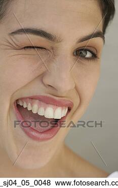 Stock Photo - young woman winking. 
fotosearch - search 
stock photos, 
pictures, images, 
and photo clipart