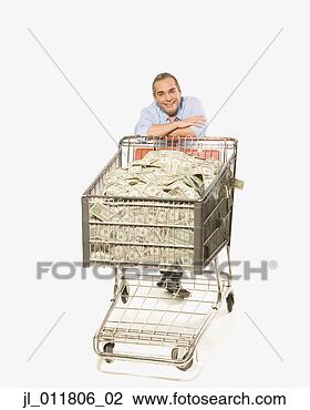 Stock Photo - businessman pushing 
shopping cart 
full of money. 
fotosearch - search 
stock photos, 
pictures, images, 
and photo clipart