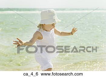 Stock Photo - little girl wading 
in the ocean. 
fotosearch - search 
stock photos, 
pictures, images, 
and photo clipart