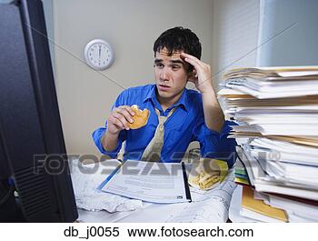 Stock Image - overwhelmed businessman 
eating fast food 
at desk. fotosearch 
- search stock 
photos, pictures, 
images, and photo 
clipart