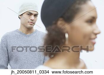 Stock Photo - young man posing 
for the camera 
with young woman 
in foreground. 
fotosearch - search 
stock photos, 
pictures, images, 
and photo clipart