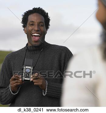 Stock Photography - young man using 
an old-fashioned 
camera. fotosearch 
- search stock 
photos, pictures, 
images, and photo 
clipart