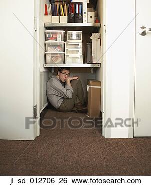 Stock Photo - businessman hiding 
in a closet. fotosearch 
- search stock 
photos, pictures, 
images, and photo 
clipart