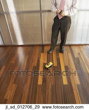 Stock Photograph - businessman playing 
with a remote-controlled 
car. fotosearch 
- search stock 
photos, pictures, 
images, and photo 
clipart