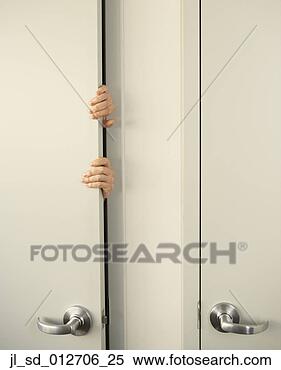 Stock Image - businessperson 
clutching door-jamb. 
fotosearch - search 
stock photos, 
pictures, images, 
and photo clipart