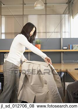 Stock Photo - businesswoman 
draping her coat 
around her chair. 
fotosearch - search 
stock photos, 
pictures, images, 
and photo clipart
