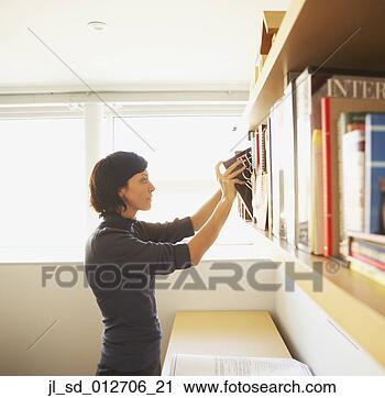 Stock Photography - businesswoman 
pulling a book 
from the bookshelf. 
fotosearch - search 
stock photos, 
pictures, images, 
and photo clipart