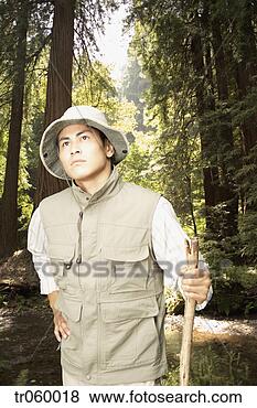 Stock Photo - explorer walking 
through jungle 
area. fotosearch 
- search stock 
photos, pictures, 
images, and photo 
clipart