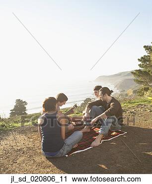 Stock Photography - friends having 
a picnic on dirt 
path. fotosearch 
- search stock 
photos, pictures, 
images, and photo 
clipart