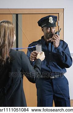Stock Photo - security guard 
checking businesswomanís 
credentials. fotosearch 
- search stock 
photos, pictures, 
images, and photo 
clipart