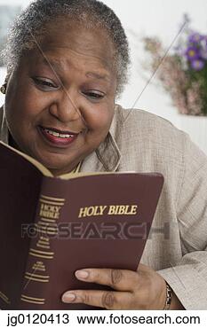 Stock Photo - senior woman reading 
the bible. fotosearch 
- search stock 
photos, pictures, 
images, and photo 
clipart