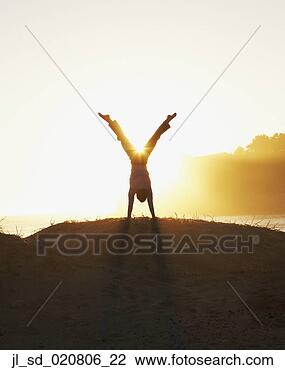 Stock Photo - silhouette of 
man doing a handstand. 
fotosearch - search 
stock photos, 
pictures, images, 
and photo clipart