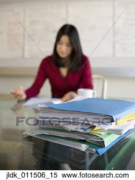 Stock Image - stack of papers 
on glass table. 
fotosearch - search 
stock photos, 
pictures, images, 
and photo clipart